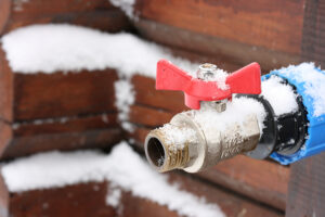 Outdoor faucet covered in snow