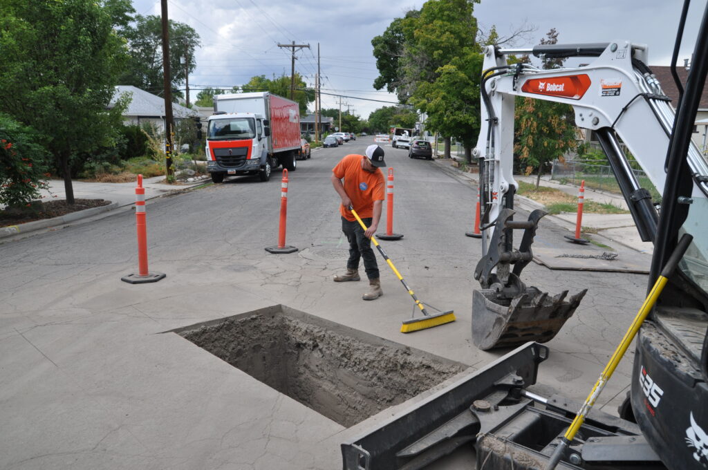 A Big Brothers expert works on a sewer line repair.