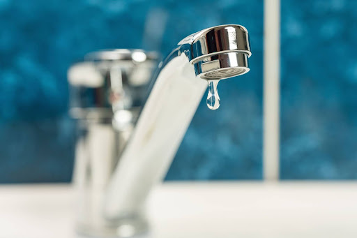 Bathroom sink faucet dripping water