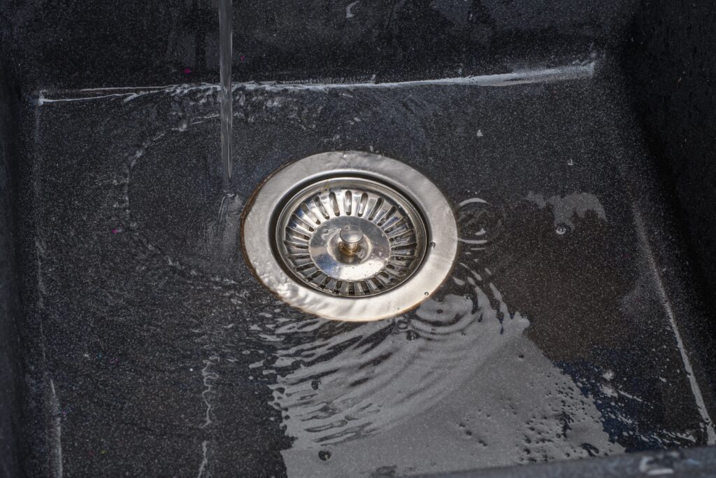 Standing water on top of clogged drain.